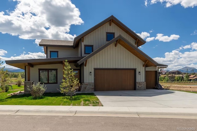 277 Hay Meadow Dr, Fraser, CO 80442 - view of front of property featuring a garage, driveway, stone siding, and a mountain view