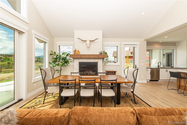 277 Hay Meadow Dr, Fraser, CO 80442 - dining space featuring vaulted ceiling, a tile fireplace, light wood-style flooring, baseboards, and recessed lighting