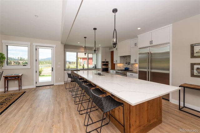 277 Hay Meadow Dr, Fraser, CO 80442 - kitchen featuring premium appliances, backsplash, light wood finished floors, baseboards, and recessed lighting