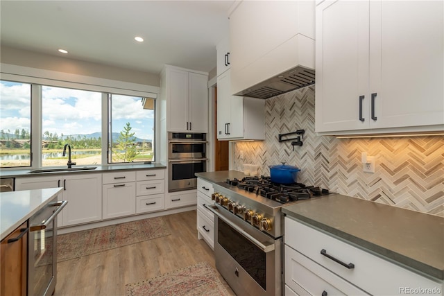 277 Hay Meadow Dr, Fraser, CO 80442 - kitchen featuring stainless steel appliances, a sink, tasteful backsplash, white cabinets, and dark countertops