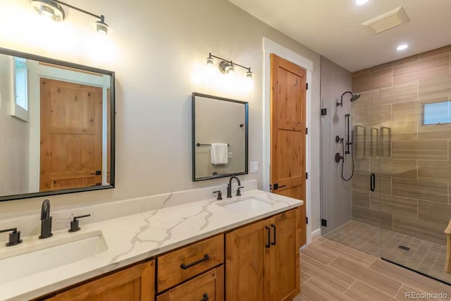 277 Hay Meadow Dr, Fraser, CO 80442 - bathroom featuring double vanity, a shower stall, recessed lighting, and wood finish floors
