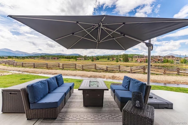 277 Hay Meadow Dr, Fraser, CO 80442 - view of patio / terrace with an outdoor living space with a fire pit, a mountain view, and a rural view