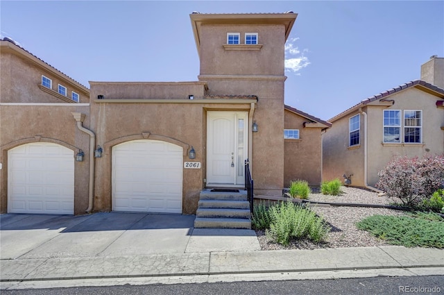 view of front of house featuring concrete driveway and stucco siding