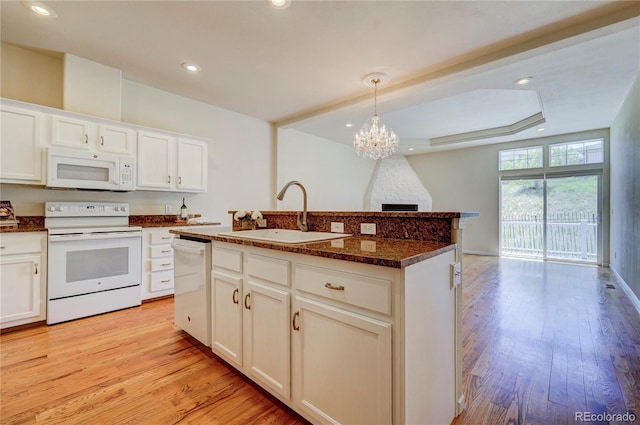 2061 Cheyenne Summer Vw, Colorado Springs, CO 80904 - kitchen with white appliances, a sink, light wood-type flooring, recessed lighting, and a tray ceiling