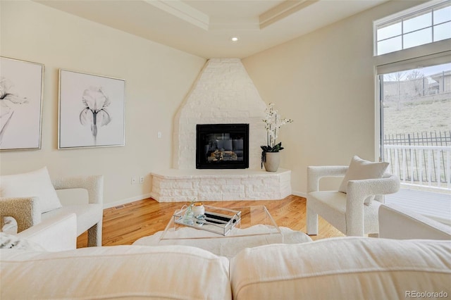2061 Cheyenne Summer Vw, Colorado Springs, CO 80904 - living room featuring a fireplace, wood finished floors, a tray ceiling, recessed lighting, and baseboards