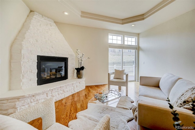 2061 Cheyenne Summer Vw, Colorado Springs, CO 80904 - living area with a stone fireplace, wood finished floors, a tray ceiling, and recessed lighting