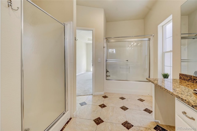 2061 Cheyenne Summer Vw, Colorado Springs, CO 80904 - bathroom featuring vanity, tile patterned floors, bath / shower combo with glass door, and baseboards