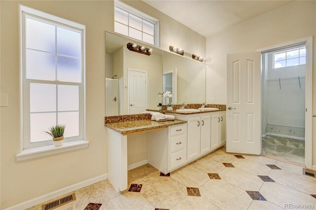 2061 Cheyenne Summer Vw, Colorado Springs, CO 80904 - bathroom with a stall shower, tile patterned flooring, vanity, baseboards, and a closet