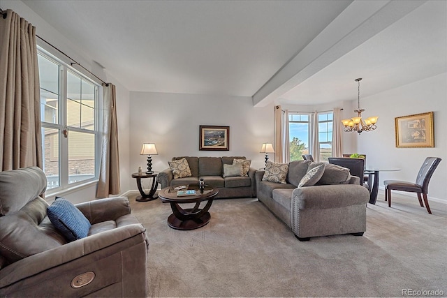 carpeted living room with an inviting chandelier