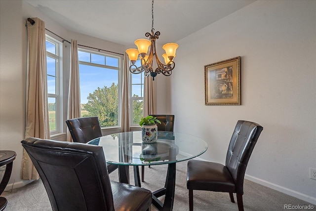 dining room with a chandelier and carpet floors