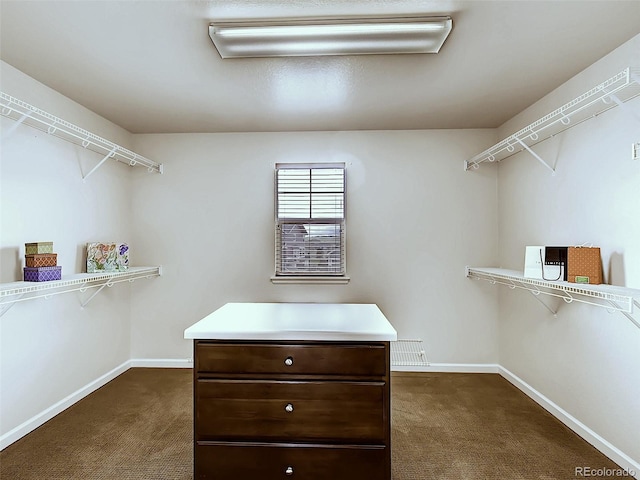 walk in closet featuring dark colored carpet