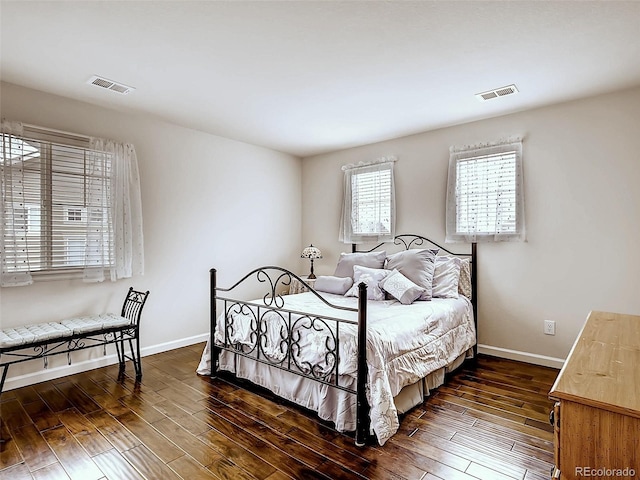 bedroom with dark hardwood / wood-style floors