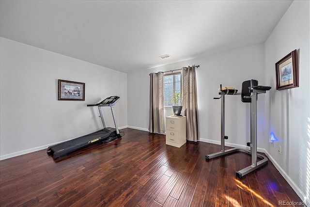 exercise room with dark hardwood / wood-style floors