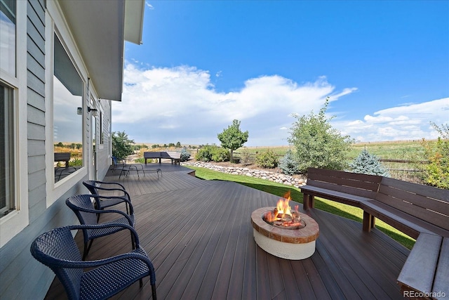 wooden deck with a fire pit