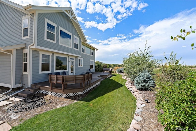 back of property with an outdoor living space, a wooden deck, and a yard