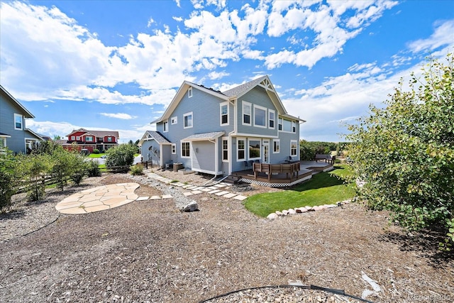 back of property featuring a deck