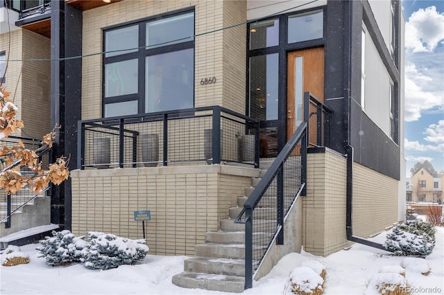 view of snow covered property entrance