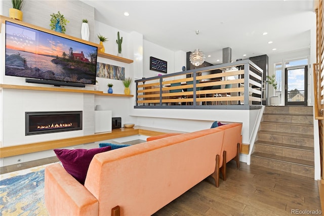 living room featuring hardwood / wood-style floors and a large fireplace