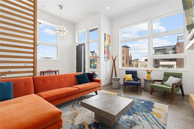 living room with hardwood / wood-style floors and an inviting chandelier