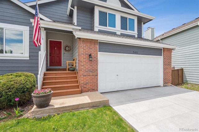 view of front of property featuring brick siding, an attached garage, and concrete driveway