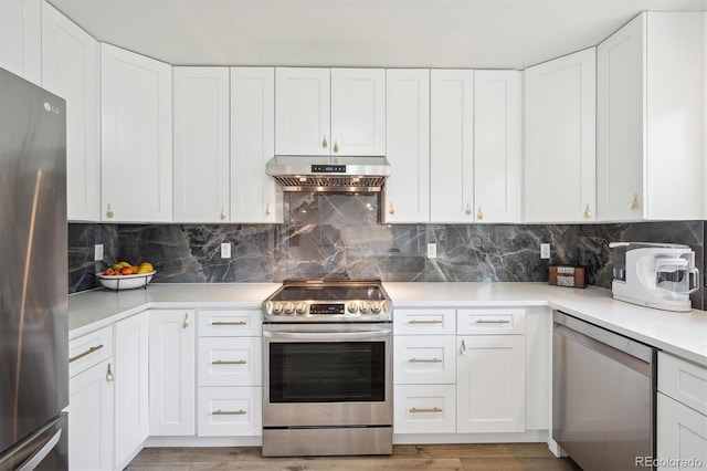 kitchen featuring stainless steel appliances, under cabinet range hood, light countertops, and white cabinets