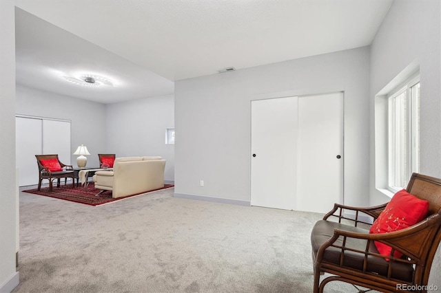 sitting room featuring carpet and baseboards