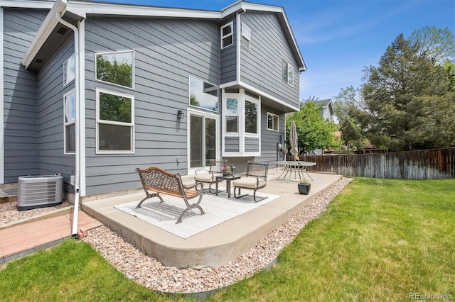 rear view of house featuring a patio and central AC