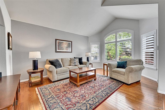 10653 W Parkhill Dr, Littleton, CO 80127 - living area with hardwood / wood-style floors, lofted ceiling, and baseboards