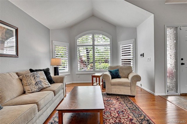 10653 W Parkhill Dr, Littleton, CO 80127 - living area with vaulted ceiling, wood finished floors, and baseboards