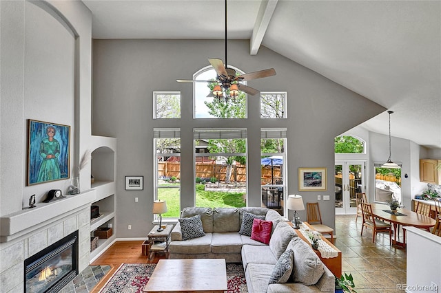 10653 W Parkhill Dr, Littleton, CO 80127 - living area featuring a ceiling fan, healthy amount of natural light, a fireplace, high vaulted ceiling, and beamed ceiling