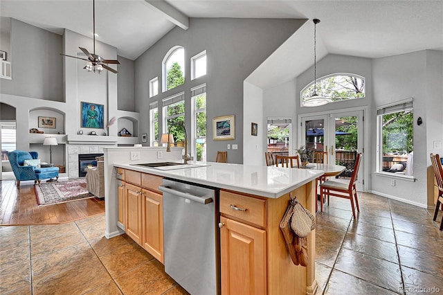 10653 W Parkhill Dr, Littleton, CO 80127 - kitchen featuring stainless steel dishwasher, plenty of natural light, a sink, ceiling fan, and high vaulted ceiling