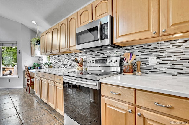 10653 W Parkhill Dr, Littleton, CO 80127 - kitchen with stainless steel appliances, lofted ceiling, tasteful backsplash, and light countertops