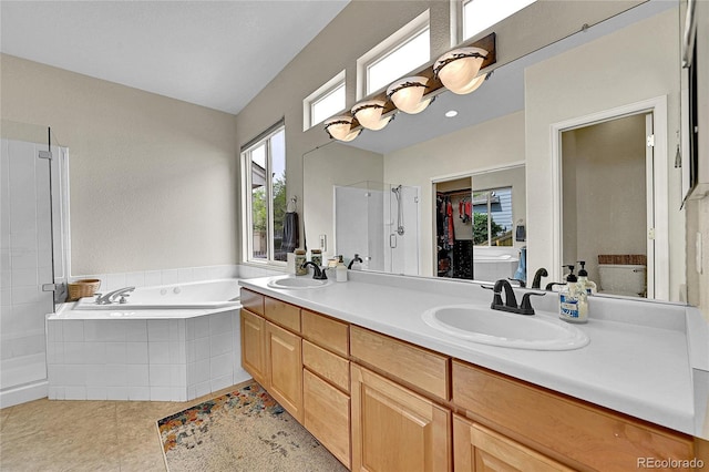 10653 W Parkhill Dr, Littleton, CO 80127 - bathroom with a stall shower, a bath, double vanity, a spacious closet, and tile patterned floors