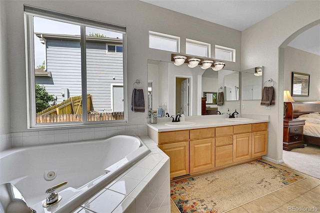 10653 W Parkhill Dr, Littleton, CO 80127 - bathroom featuring a jetted tub, connected bathroom, double vanity, and tile patterned flooring
