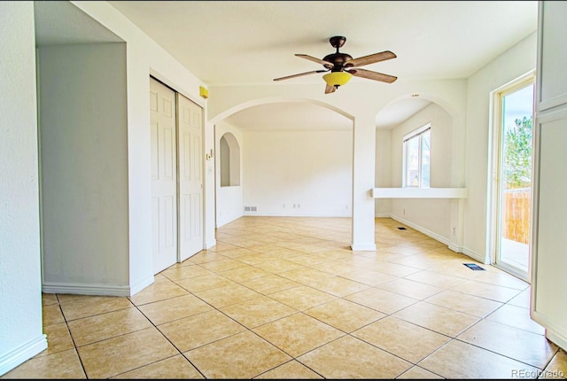 spare room featuring ceiling fan and light tile patterned floors