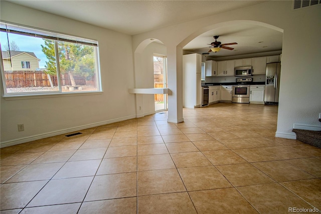 unfurnished living room with light tile patterned floors and ceiling fan