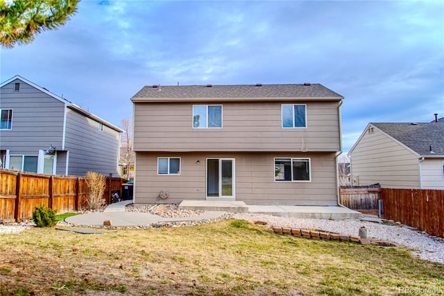 rear view of house featuring a lawn and a patio area