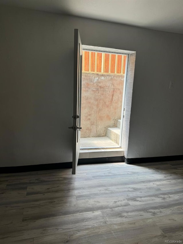 unfurnished room with hardwood / wood-style flooring