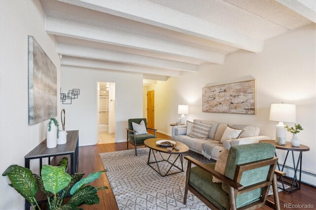 4801 E 9th Ave Unit 402S, Denver, CO 80220 - living room with beamed ceiling, wood finished floors, and a baseboard radiator