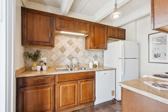4801 E 9th Ave Unit 402S, Denver, CO 80220 - kitchen featuring white appliances, a sink, beamed ceiling, decorative backsplash, and light countertops