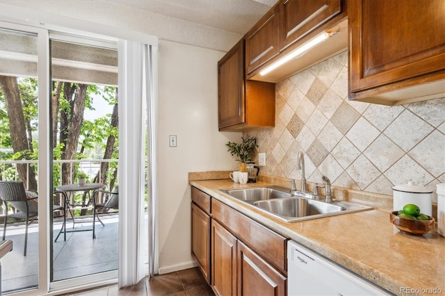 4801 E 9th Ave Unit 402S, Denver, CO 80220 - kitchen featuring a sink, tasteful backsplash, dishwasher, and light countertops