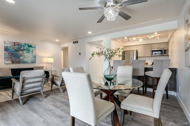 dining space featuring ceiling fan and light hardwood / wood-style flooring