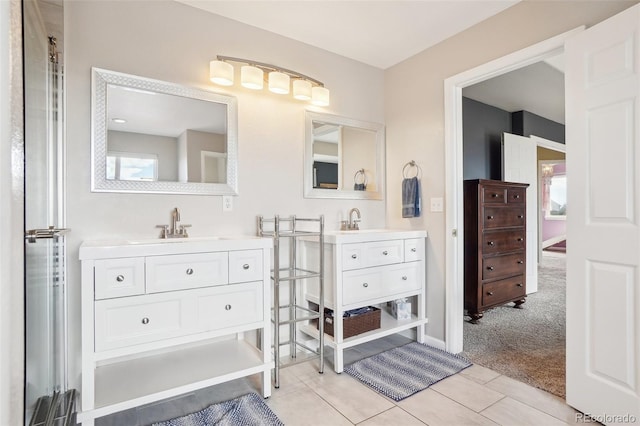 full bathroom with two vanities, a sink, and tile patterned flooring