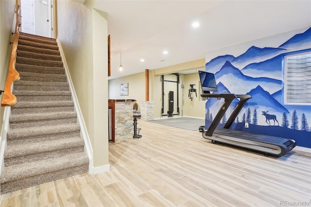 exercise room featuring baseboards, recessed lighting, and wood finished floors