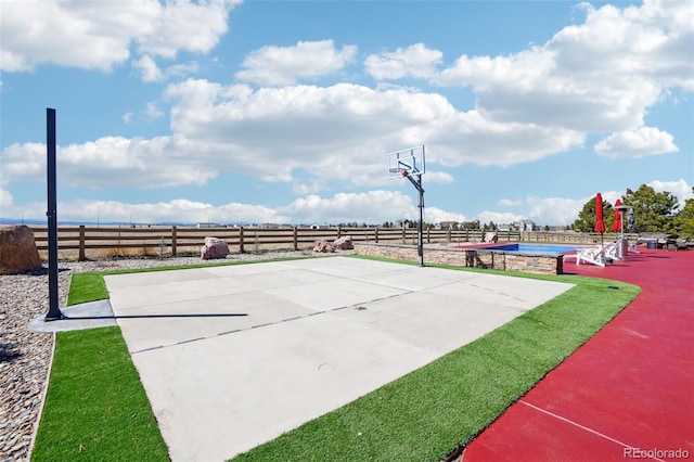 view of sport court with community basketball court, fence, and a pool
