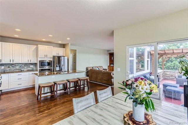 dining space with recessed lighting and dark wood finished floors