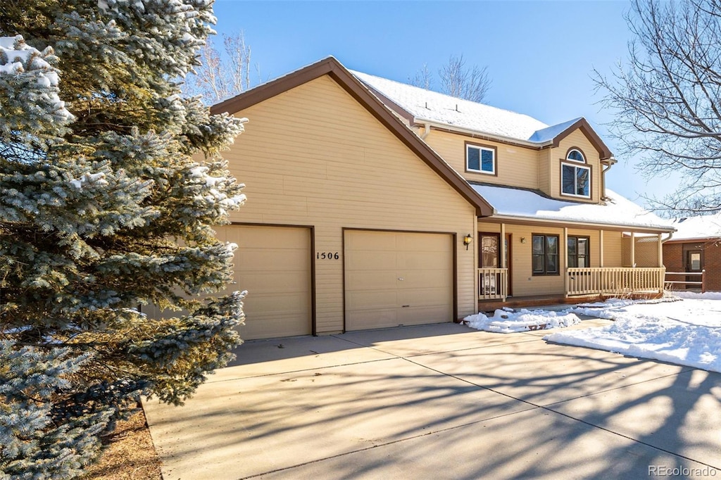 view of front of home with a porch and a garage