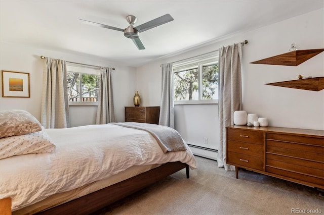 bedroom with carpet floors, a baseboard heating unit, and ceiling fan