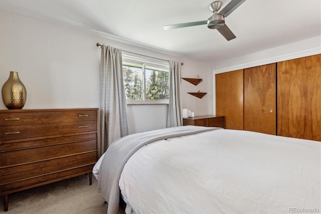 bedroom with carpet flooring, a closet, and a ceiling fan