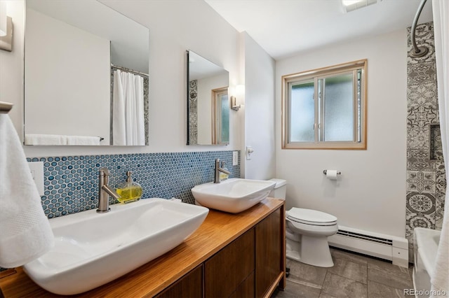 bathroom featuring baseboard heating, toilet, double vanity, tasteful backsplash, and a shower with curtain